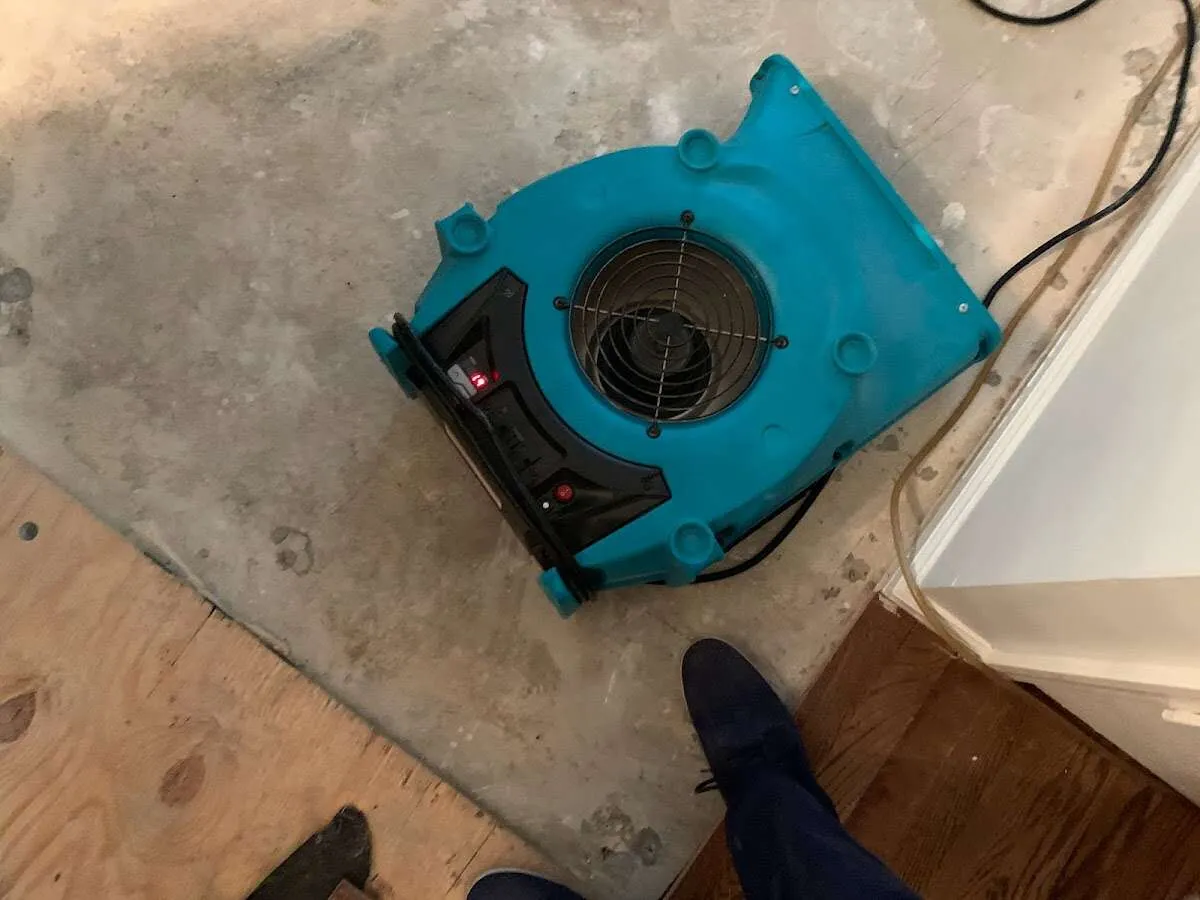 Air mover drying subfloor during Commercial Water Damage Restoration in Boone